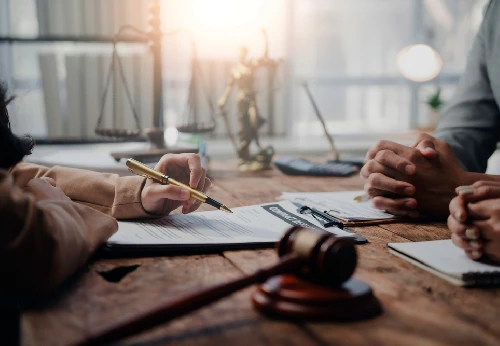 Lawyer showing contract details to clients legal consulting