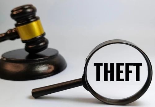 Theft criminal charge concept with gavel and magnifying glass